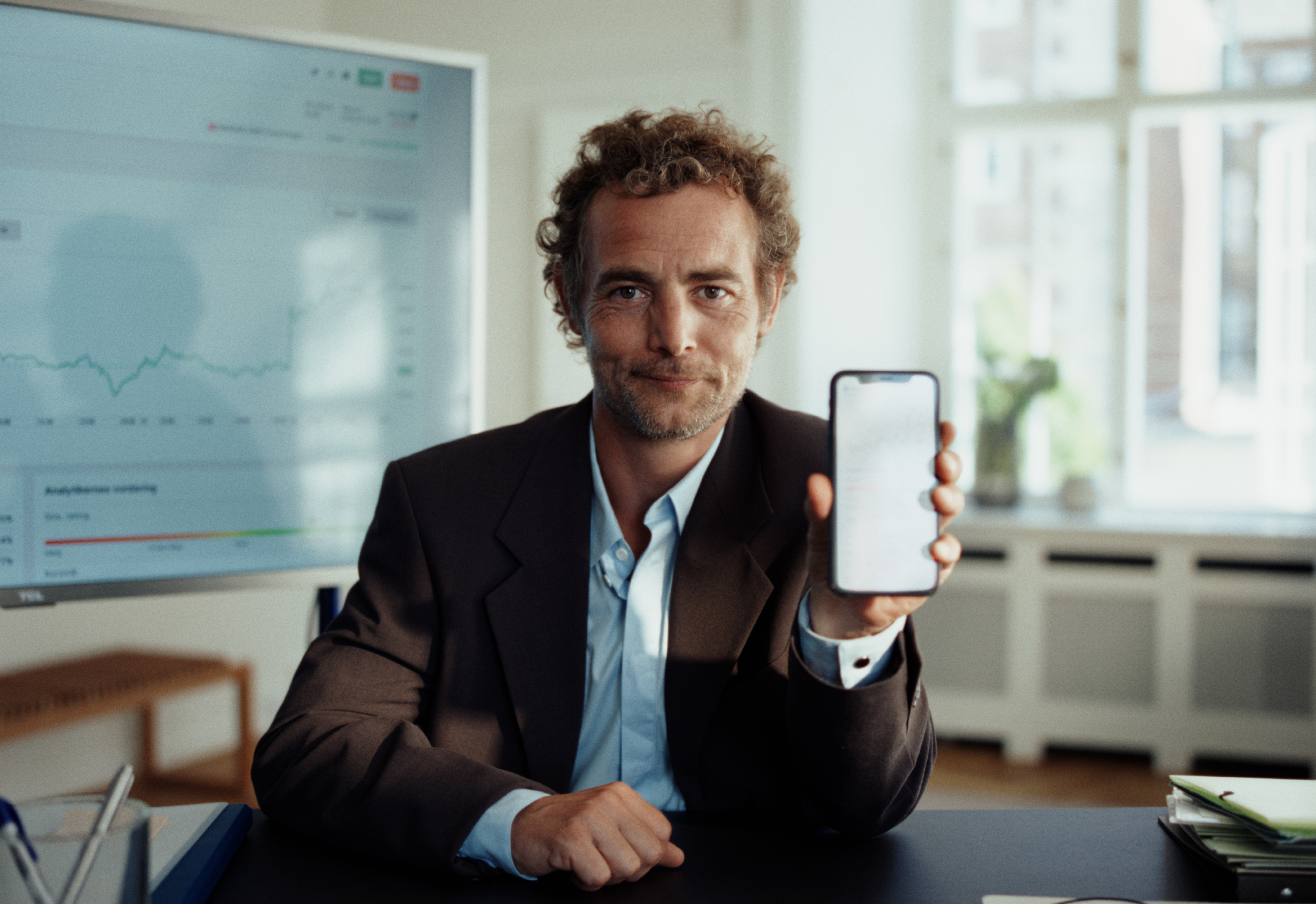 investeringloesning-mobiltelefon-med-person.png